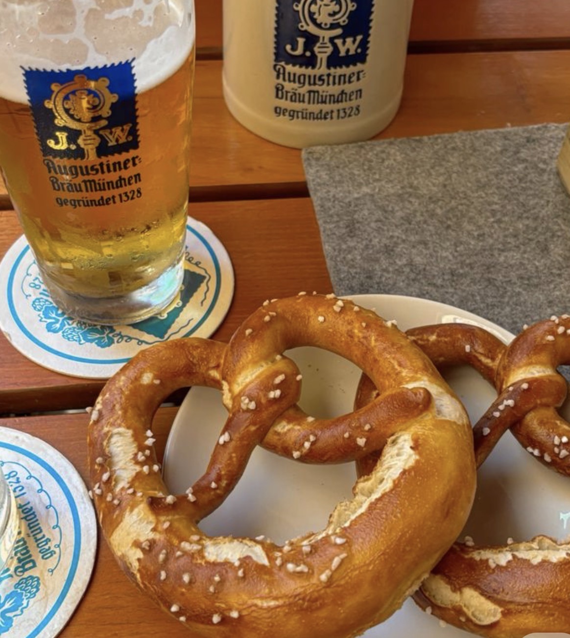 Salted pretzels and a beer on a wooden table