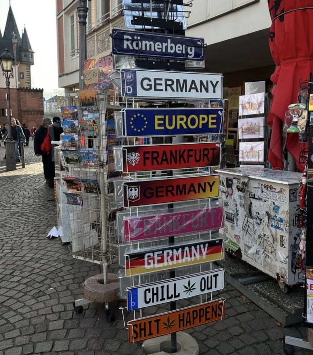 Souvenir plates and postcards on a cobblestone street