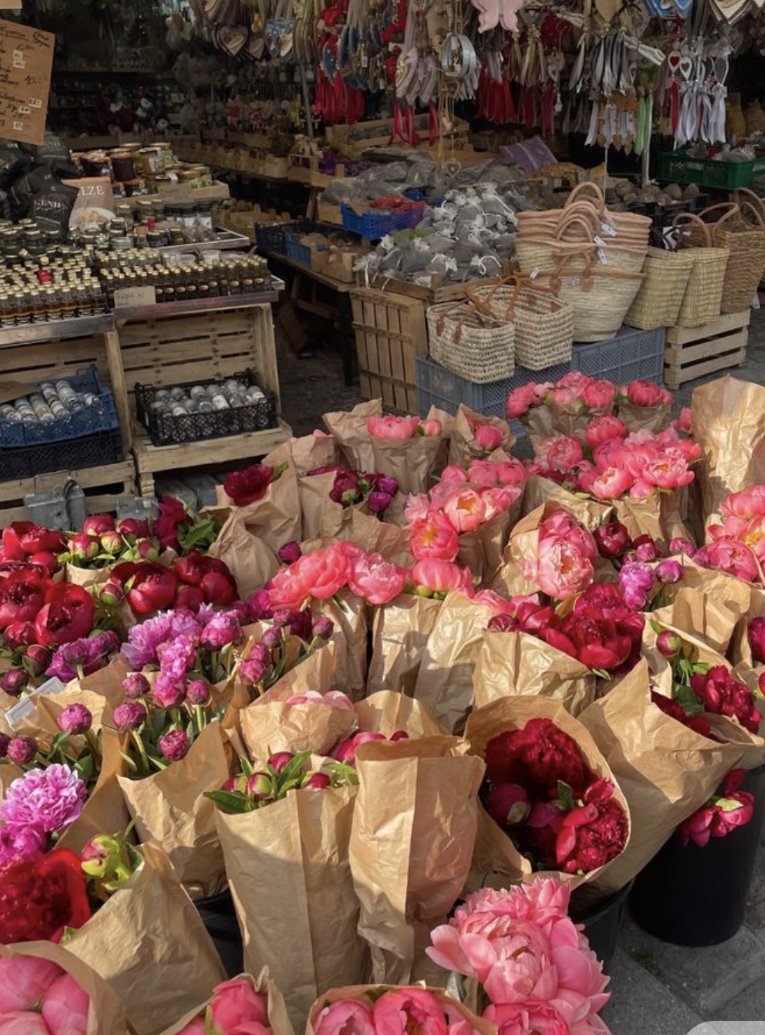 Peonies wrapped in paper at an open-air market